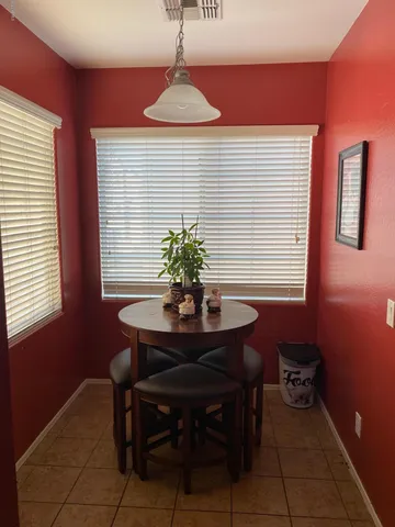 a dining room with furniture and window