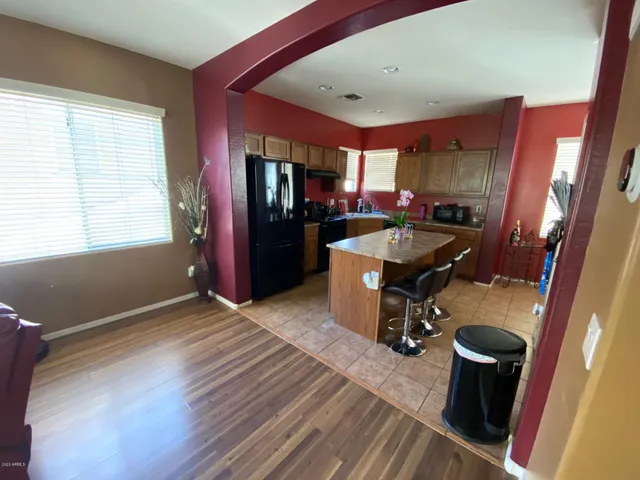 a kitchen with a refrigerator and a sink