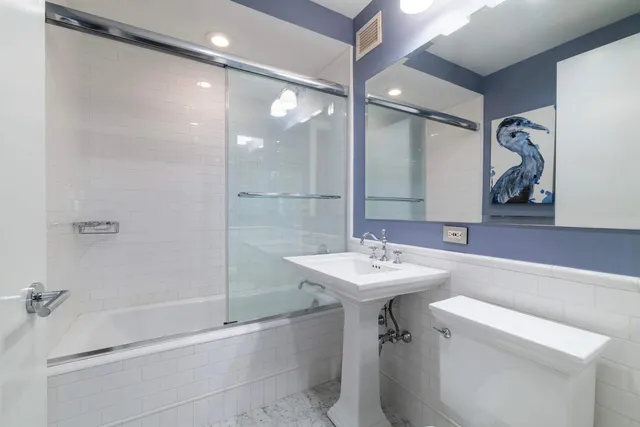 a spacious bathroom with a bathtub sink and mirror