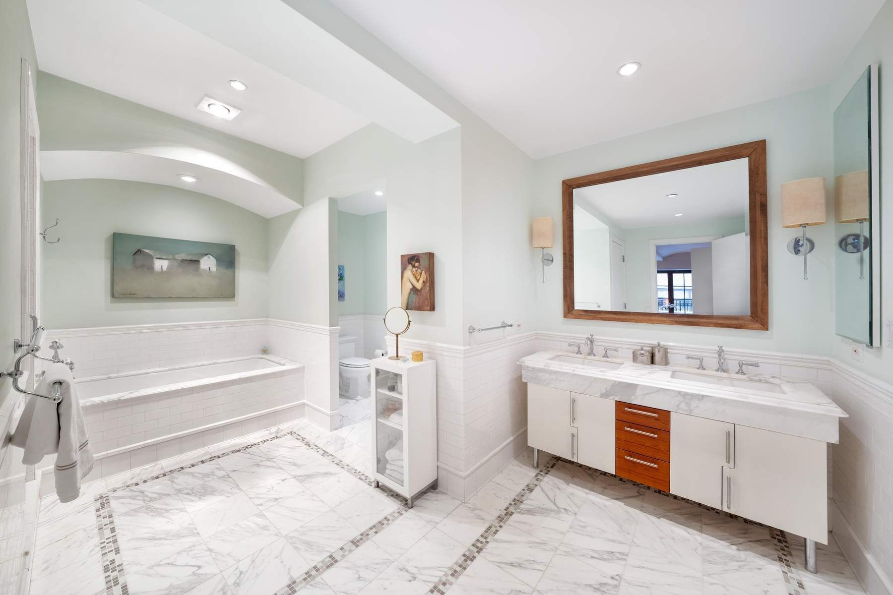 43 West 64th Street, Unit 4B Manhattan, NY 10023 - Photo 9 of 15 a spacious bathroom with a tub sink double vanity and a mirror