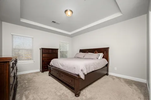 a spacious bedroom with a bed and window