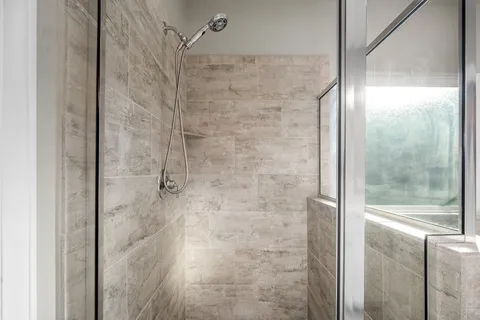 a bathroom with a glass shower door