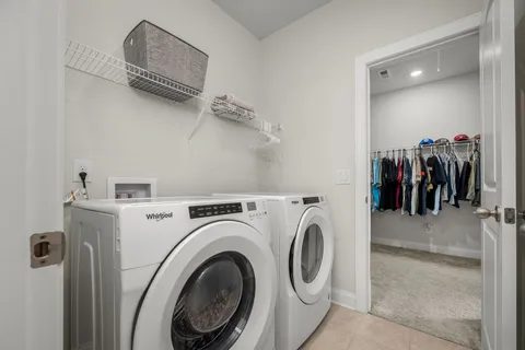 a view of storage and utility room with washer and dryer