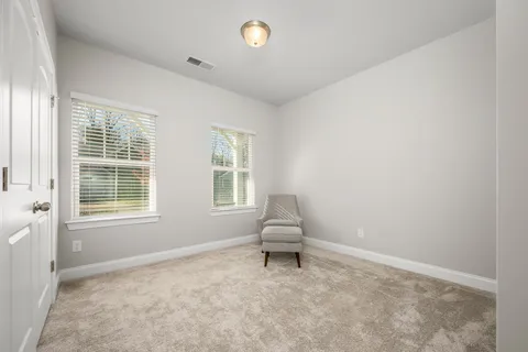 a bathroom with a granite countertop sink a toilet and a mirror