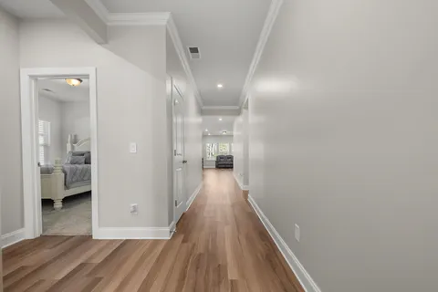 a view of a hallway with wooden floor