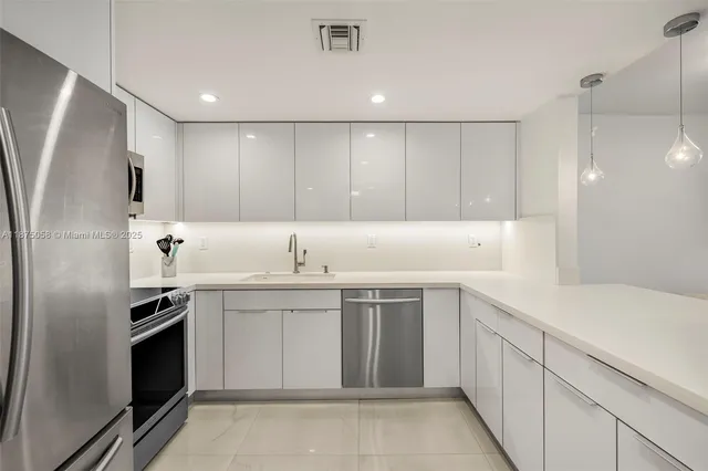 a kitchen with a sink stainless steel appliances and cabinets