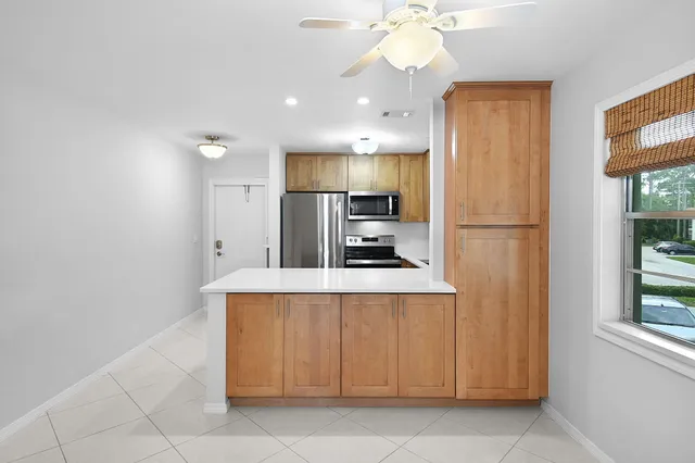 a kitchen with stainless steel appliances a refrigerator and a stove top oven