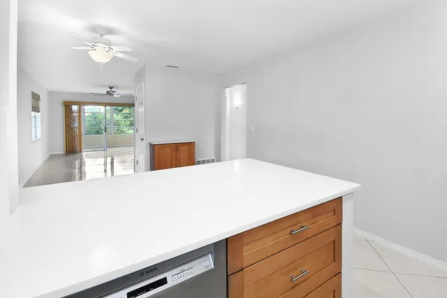 a room with a bed cabinets and a window