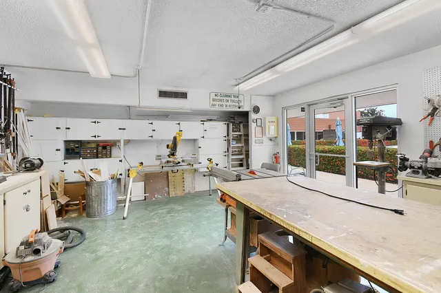 a living room with furniture gym equipment and view of bathroom