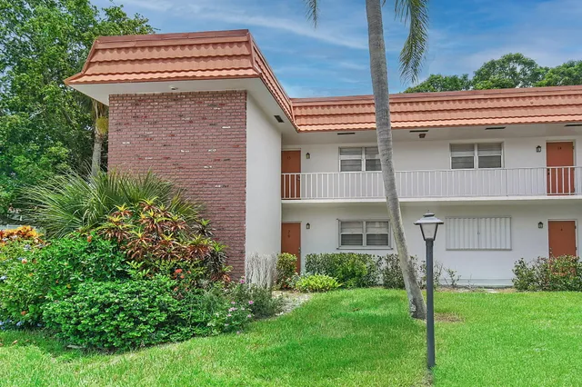 a view of a house with potted plants