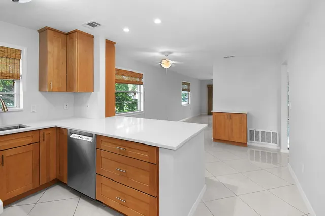 a kitchen with a sink cabinets and a window