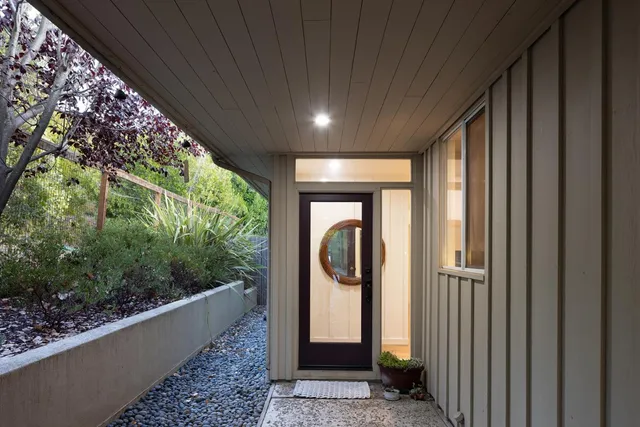 a view of a hallway with wooden floor and a sink