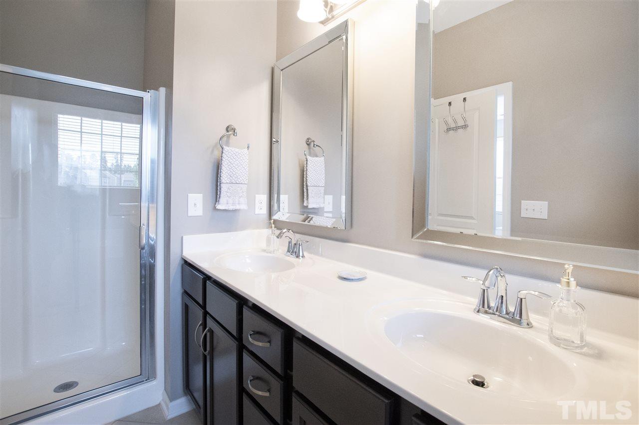 725 Wickham Ridge Road Apex, NC 27539 - Photo 12 of 30 Master Bathroom features Dual Vanity with Updated Mirrors and Walk-In Shower with Glass Door