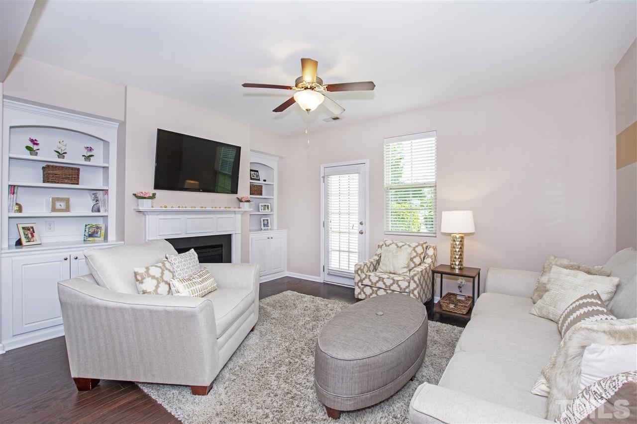 725 Wickham Ridge Road Apex, NC 27539 - Photo 3 of 30 Spacious Living Room features Gas Fireplace and Built-In Shelving