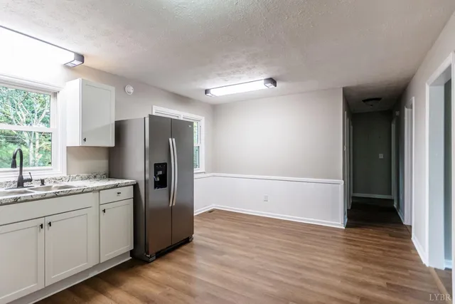 a kitchen with stainless steel appliances granite countertop a refrigerator sink and cabinets