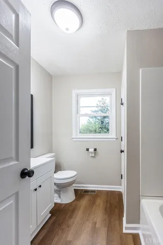 a view of bathroom with a toilet sink and a mirror