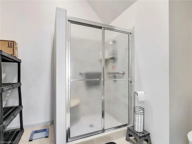 a bathroom with a glass shower door