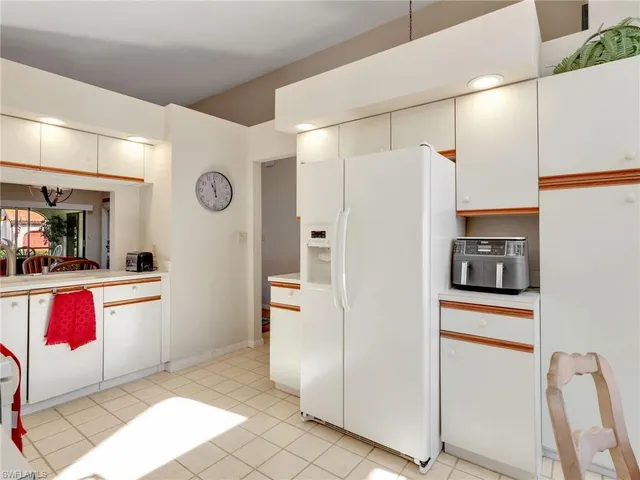 a kitchen with stainless steel appliances granite countertop a refrigerator and a stove