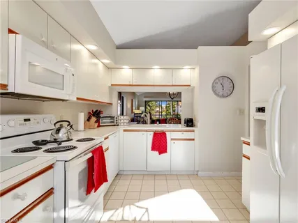 a kitchen with a sink a stove and cabinets