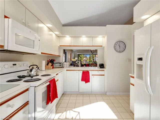 a kitchen with a sink a stove and cabinets