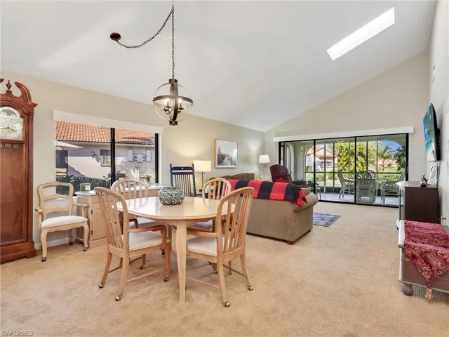 a dining room with furniture a chandelier and a rug