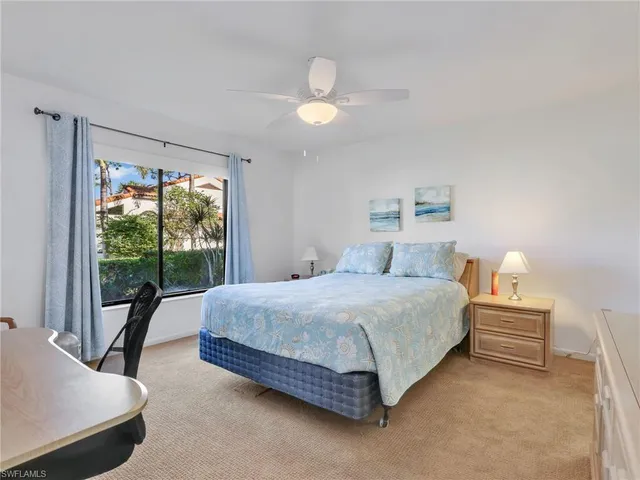 a spacious bedroom with a bed and a large window