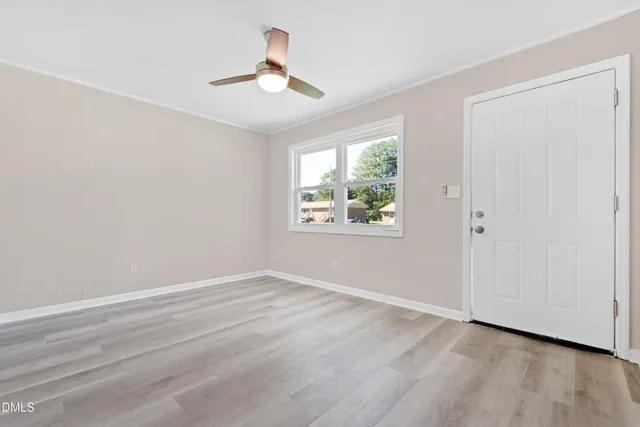 wooden floor in an empty room with a window