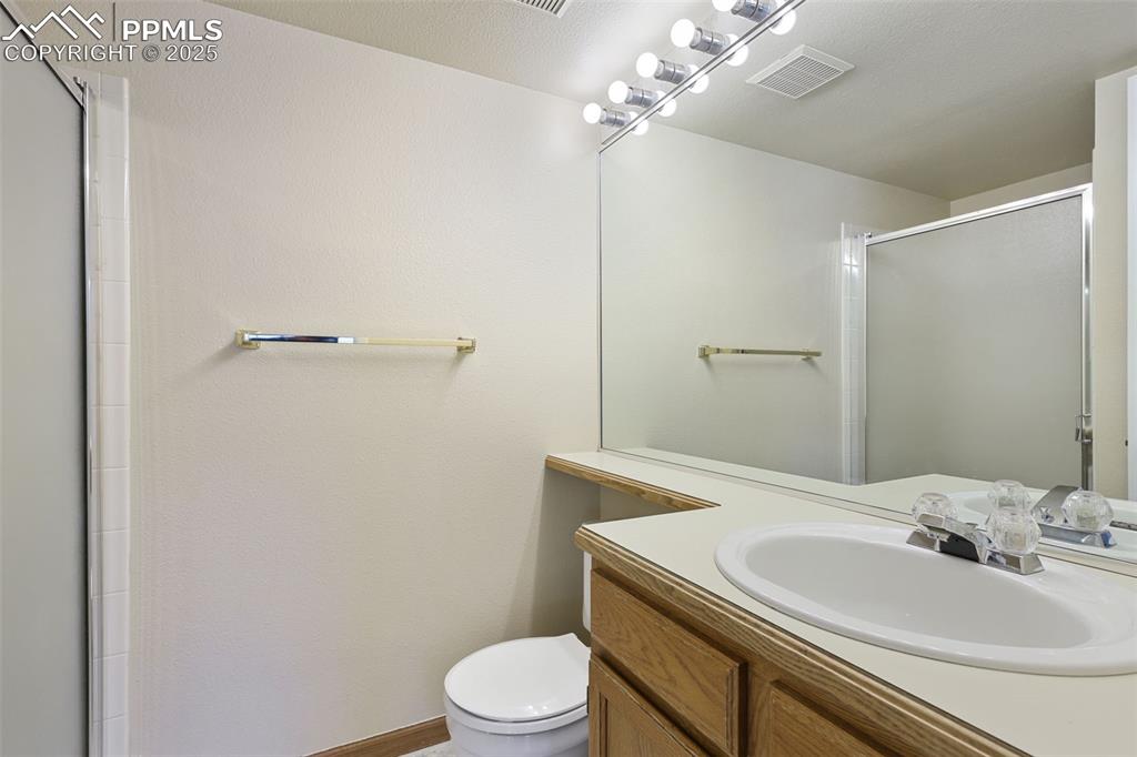 2575 Hatch Circle Colorado Springs, CO 80918 - Photo 13 of 39 a bathroom with a sink a toilet and shower