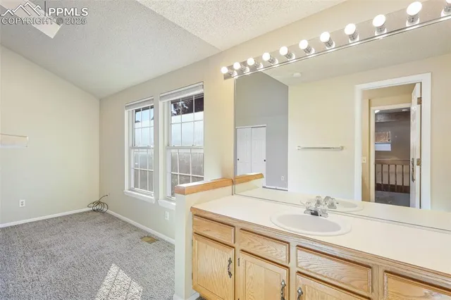 a bathroom with a sink vanity and a mirror