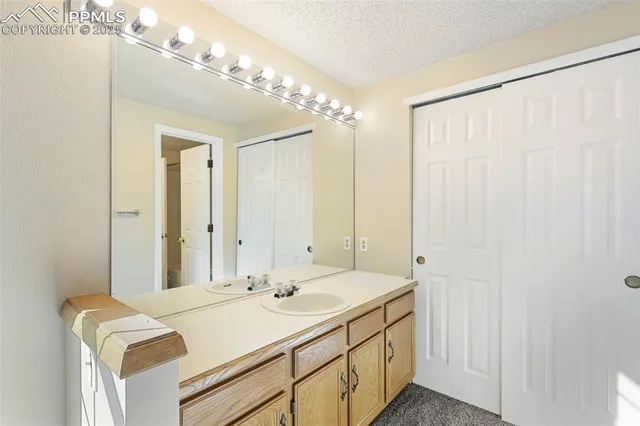 a bathroom with a double vanity sink and a mirror