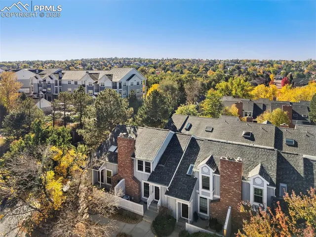 an aerial view of a house with a yard
