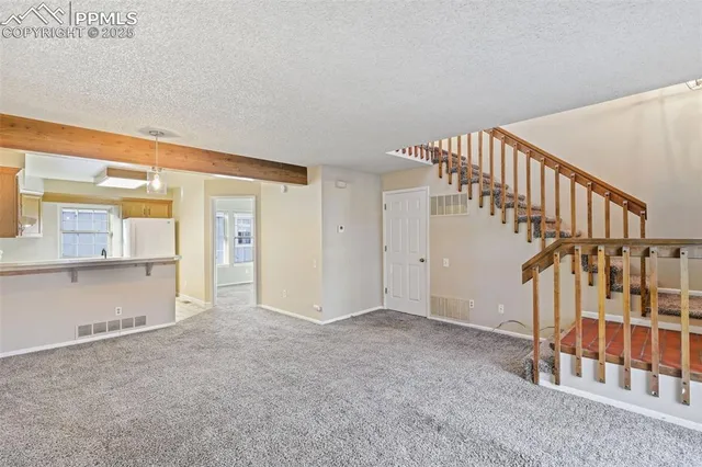 a view of an empty room with stairs