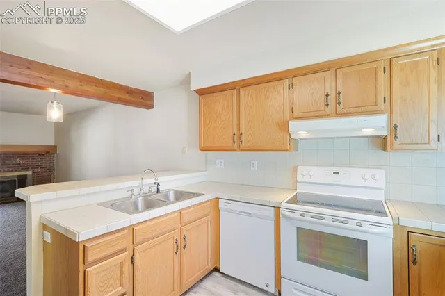 a kitchen with a sink cabinets and appliances