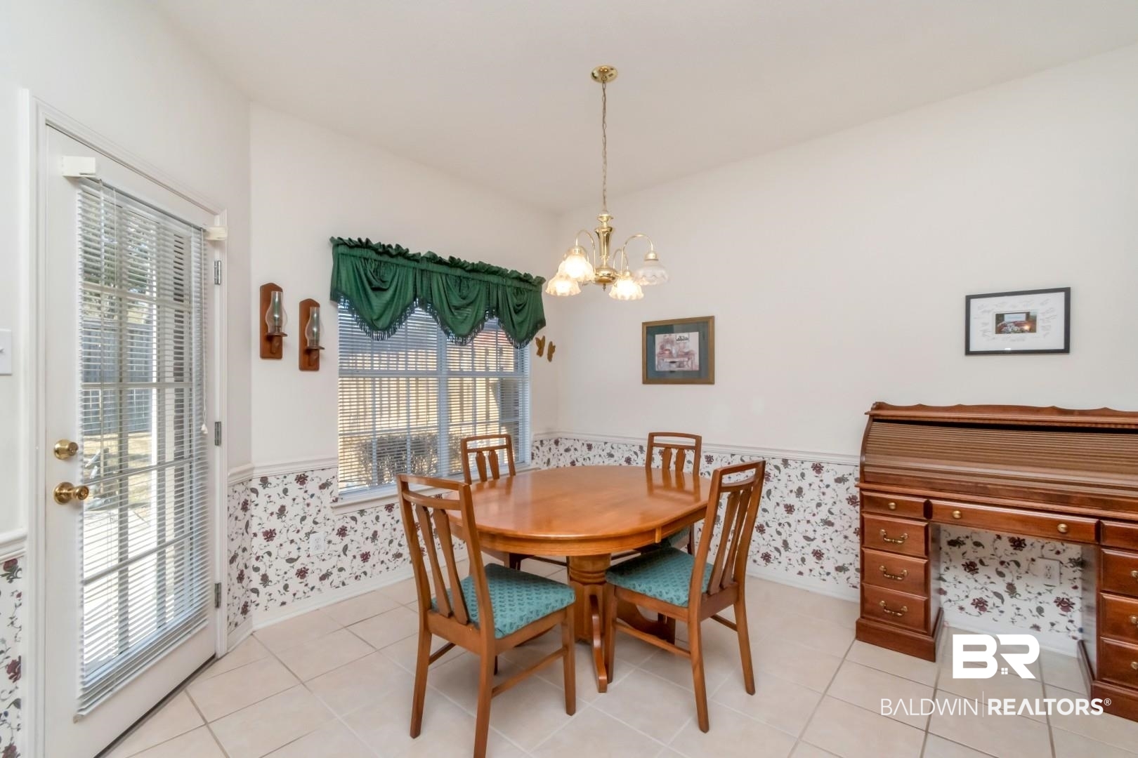 1032 Cross Gates Place Mobile, AL 36609 - Photo 8 of 34 Dining room with wainscoting, a chandelier, wallpapered walls, and light tile patterned flooring