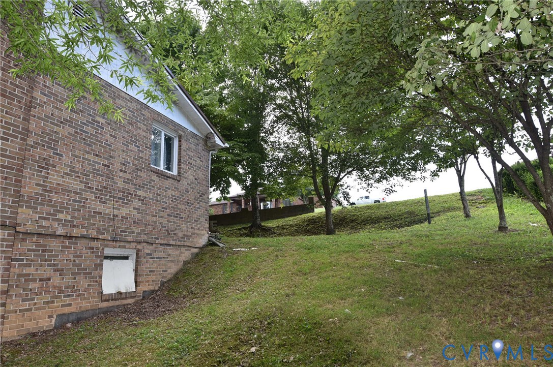 642 Star Street Pounding Mill, VA 24637 - Photo 3 of 20 Brick exterior featuring a white-framed window