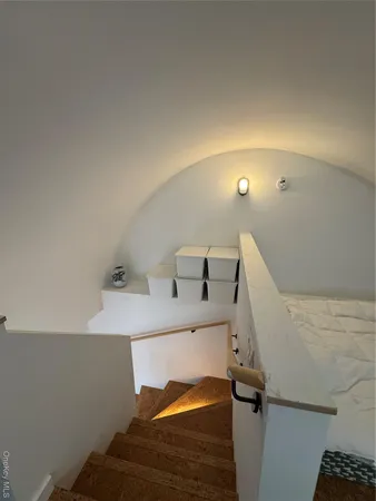a bedroom with a bed and a night stand