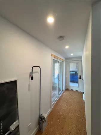 a view of a room with large windows and cabinet