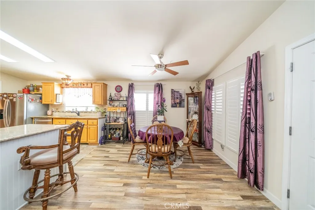 22241 Nisqually Road, Unit 153 Apple Valley, CA 92307 - Photo 11 of 55 a view of a dining room with furniture and wooden floor