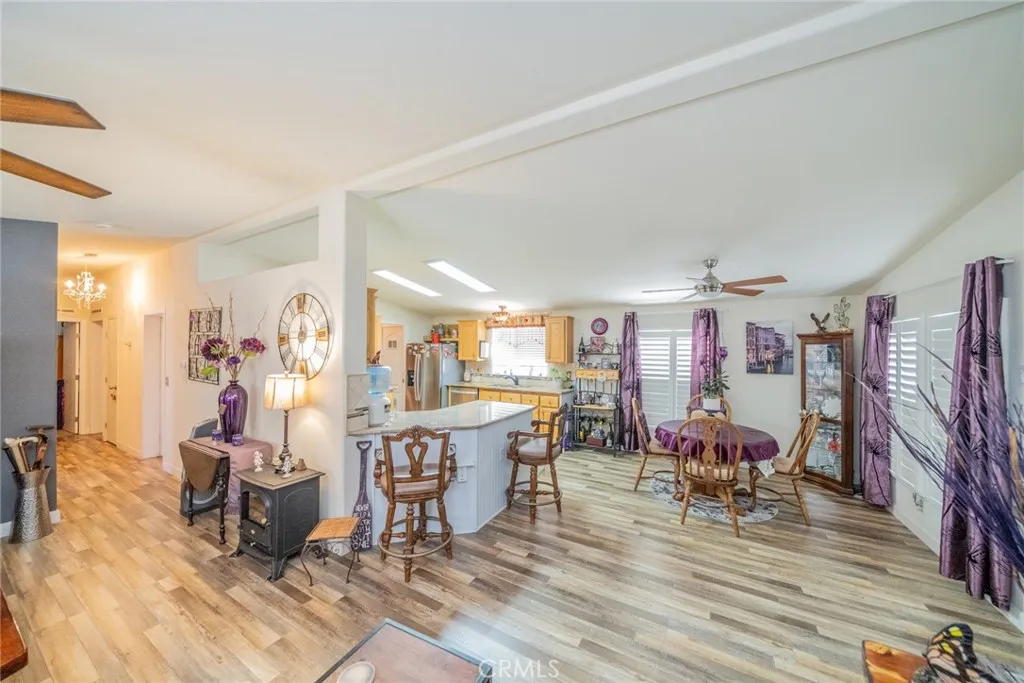 22241 Nisqually Road, Unit 153 Apple Valley, CA 92307 - Photo 13 of 55 a view of a dining room with furniture window and wooden floor