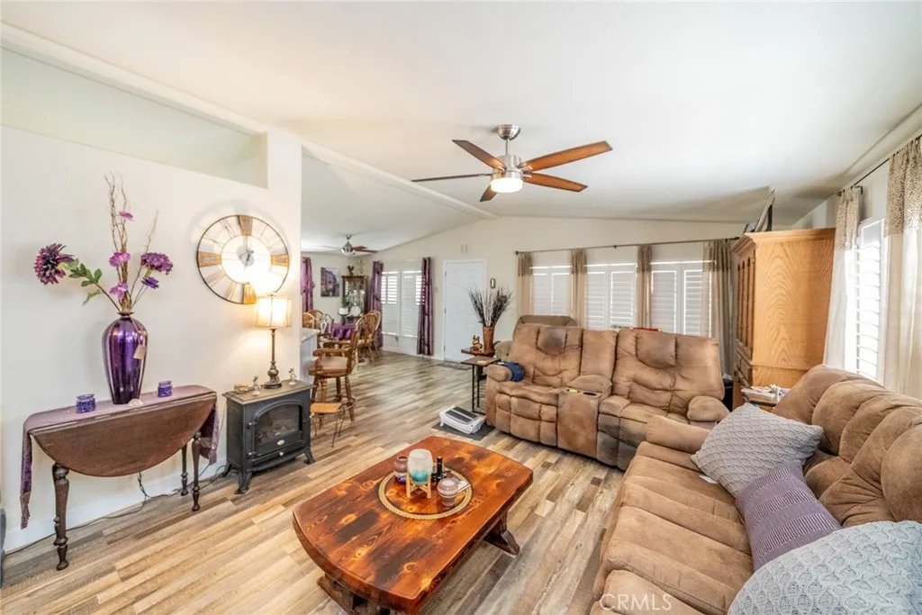22241 Nisqually Road, Unit 153 Apple Valley, CA 92307 - Photo 16 of 55 a living room with furniture a clock and a window