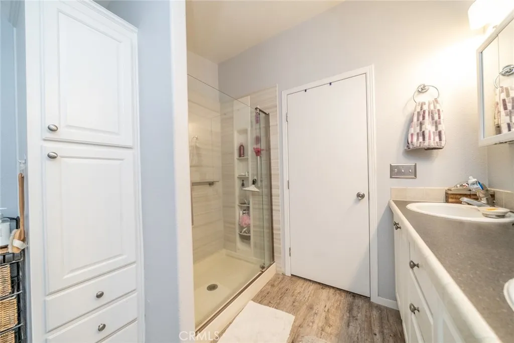 22241 Nisqually Road, Unit 153 Apple Valley, CA 92307 - Photo 23 of 55 a bathroom with a sink a mirror and a shower