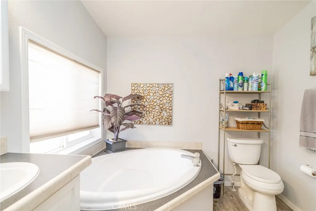 22241 Nisqually Road, Unit 153 Apple Valley, CA 92307 - Photo 24 of 55 a bathroom with a sink a toilet and a bathtub