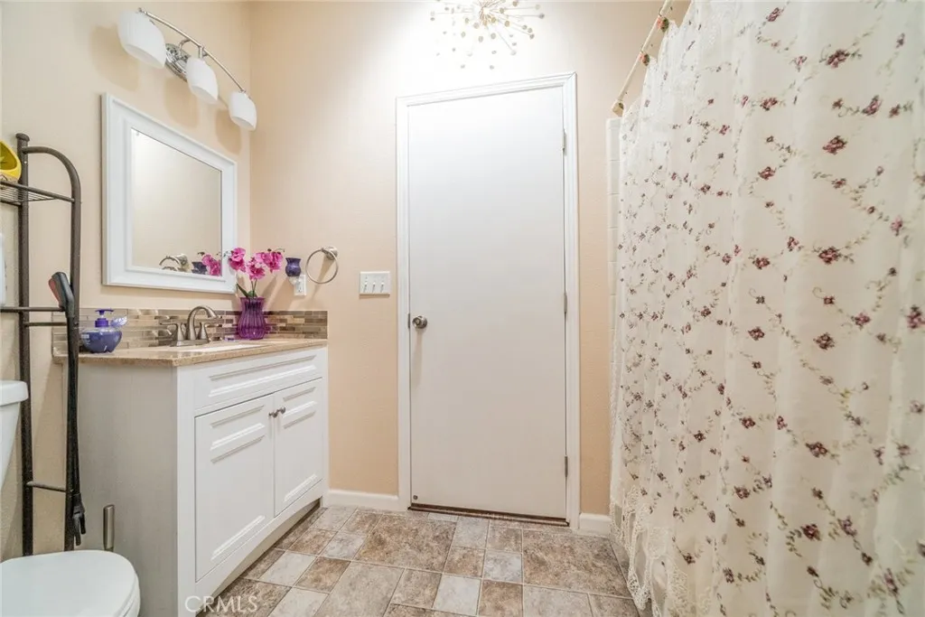 22241 Nisqually Road, Unit 153 Apple Valley, CA 92307 - Photo 29 of 55 a bathroom with a sink toilet and shower