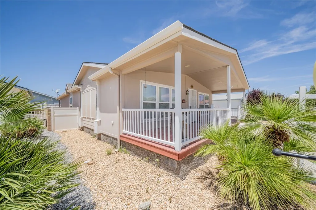 22241 Nisqually Road, Unit 153 Apple Valley, CA 92307 - Photo 3 of 55 a view of a house with a small yard and wooden floor and fence