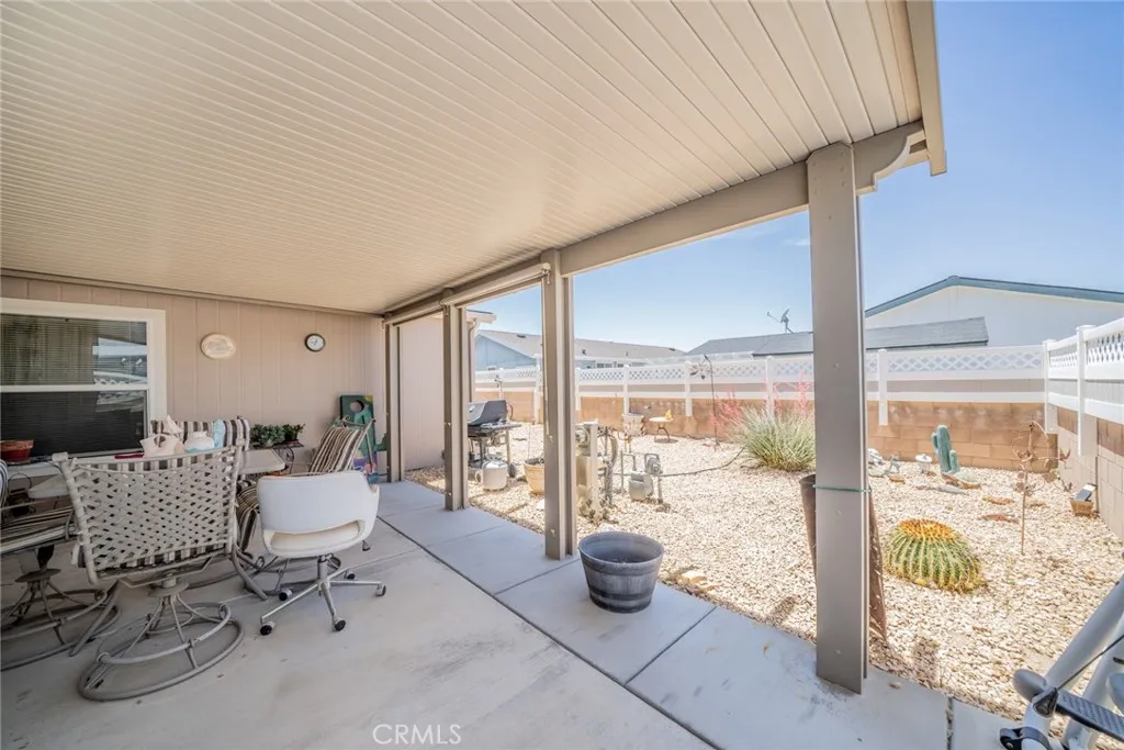 22241 Nisqually Road, Unit 153 Apple Valley, CA 92307 - Photo 32 of 55 a living room with furniture and a floor to ceiling window