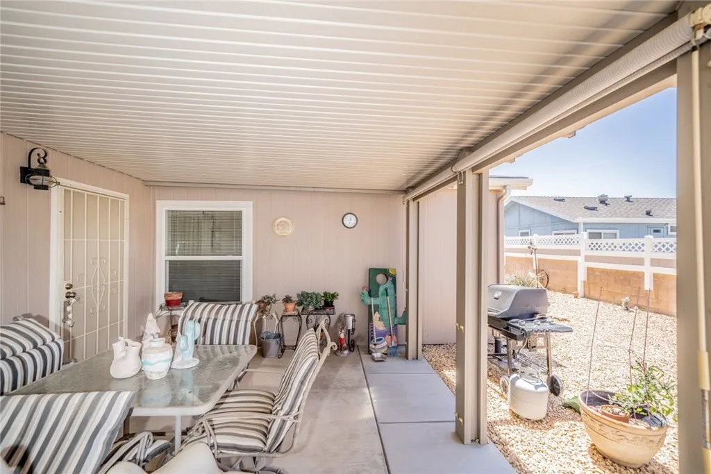 22241 Nisqually Road, Unit 153 Apple Valley, CA 92307 - Photo 33 of 55 a balcony with furniture and a potted plant