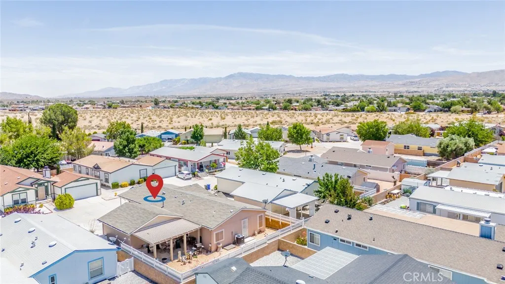 22241 Nisqually Road, Unit 153 Apple Valley, CA 92307 - Photo 40 of 55 an aerial view of residential house with outdoor space and mountain view in back