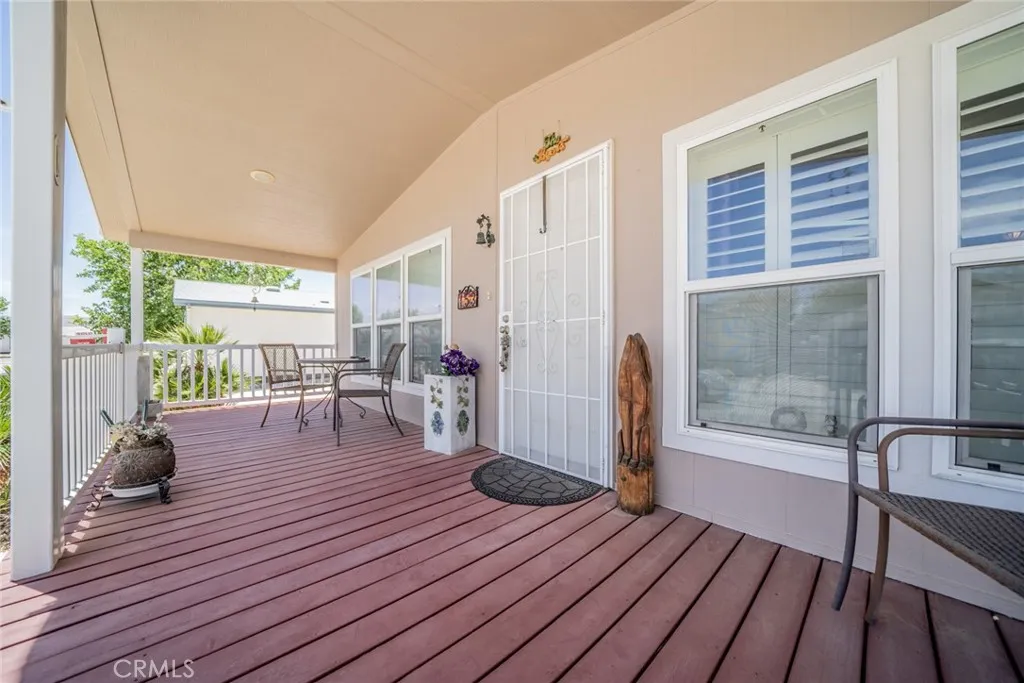 22241 Nisqually Road, Unit 153 Apple Valley, CA 92307 - Photo 4 of 55 a living room with furniture a wooden floor and floor to ceiling windows