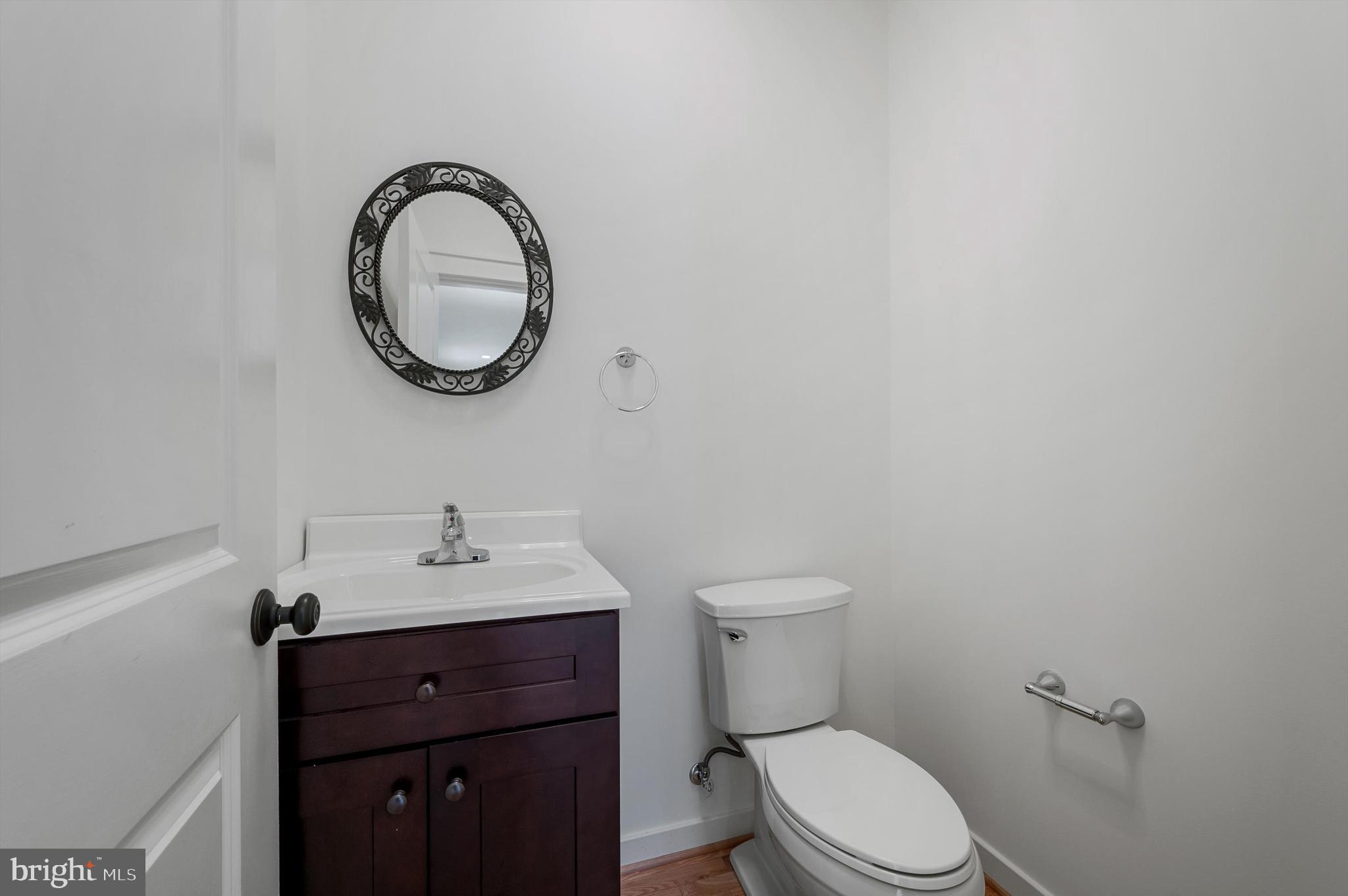 105 Loretto Drive Clear Brook, VA 22624 - Photo 25 of 65 a bathroom with a toilet sink vanity and mirror