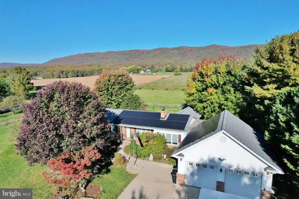 a view of a house with a mountain in the background